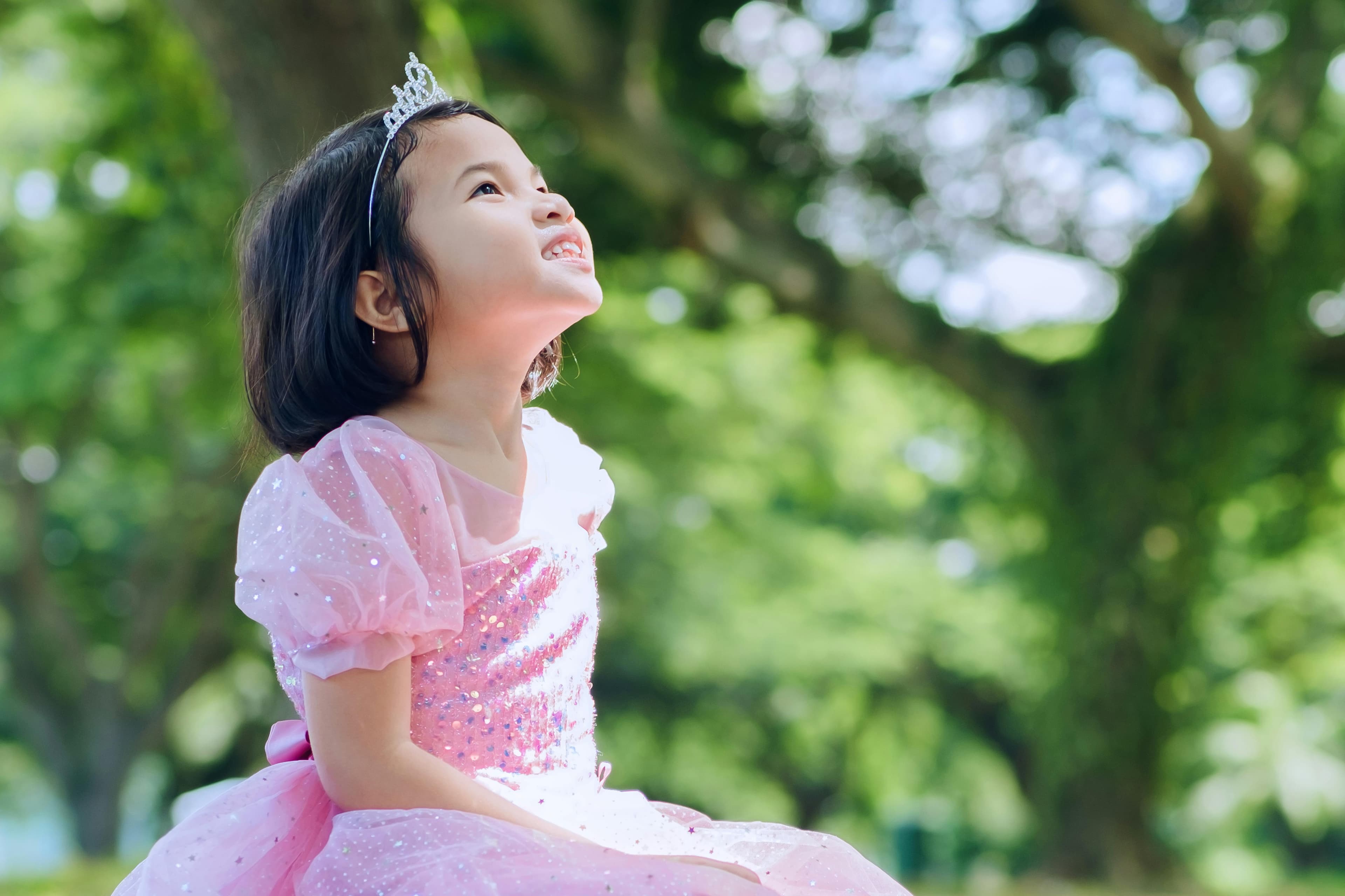 Loving grandparents gift personalized photo blanket to little girl, creating lifelong memories.