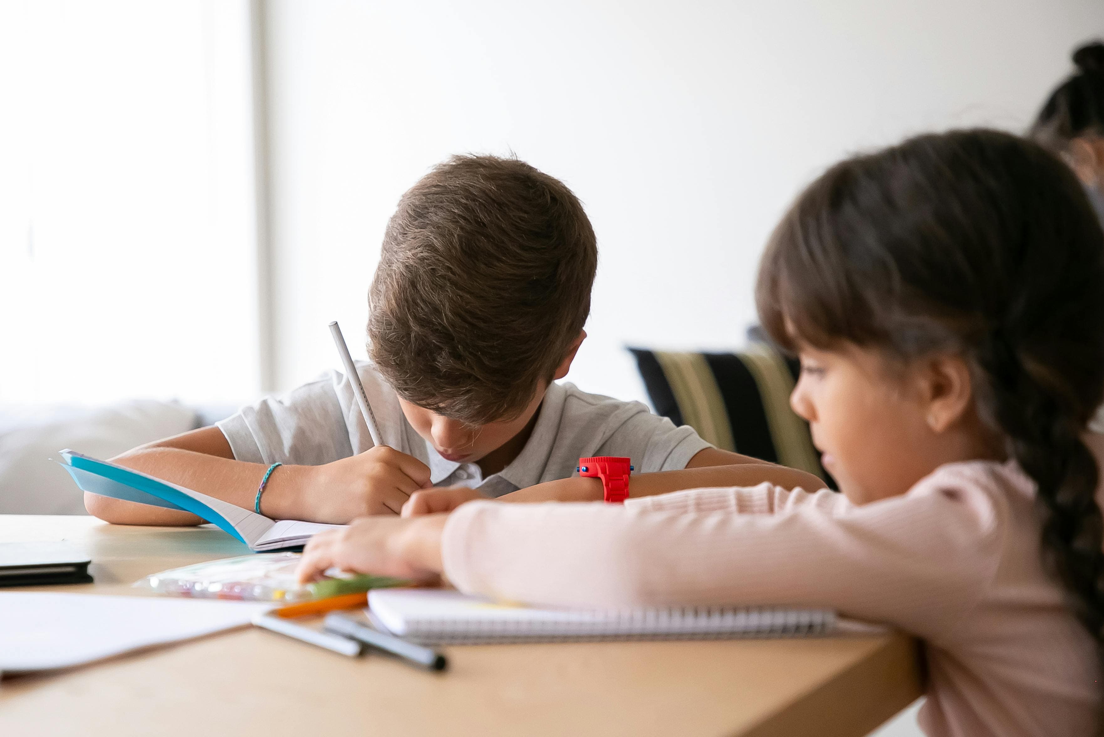 Young child drawing and colouring at a table