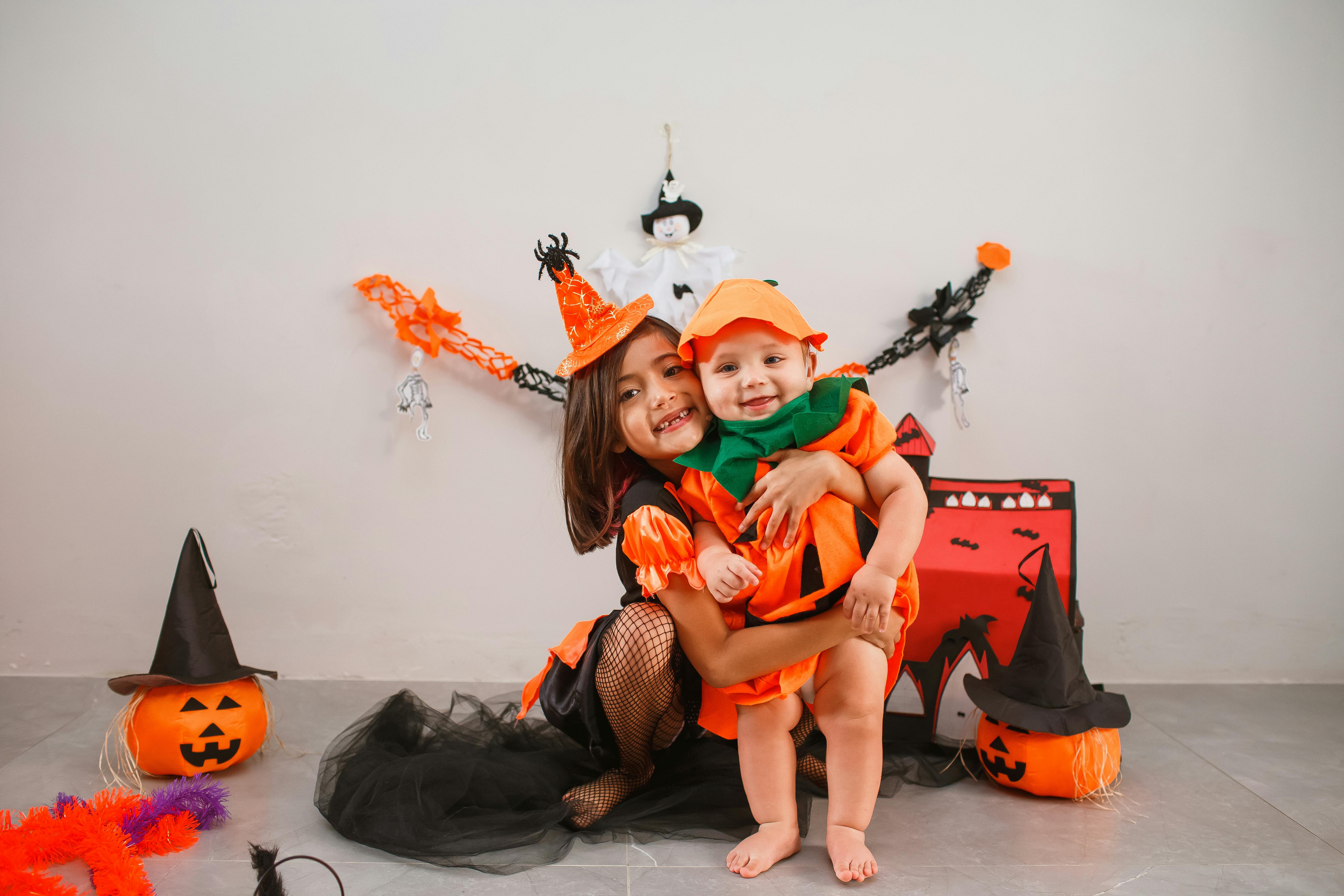 Kids in pumpkin Halloween costumes for themed boo basket ideas by age